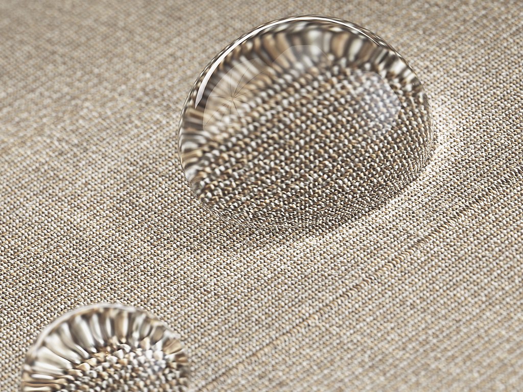 Close-up of water droplets on a textured beige surface. Close-up of water droplets on a textured beige surface.