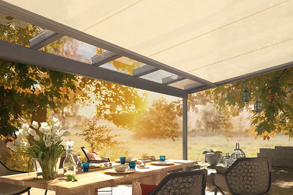 A tranquil outdoor dining area with a light-coloured cover and wooden table surrounded by chairs and greenery. A tranquil outdoor dining area with a light-coloured cover and wooden table surrounded by chairs and greenery.