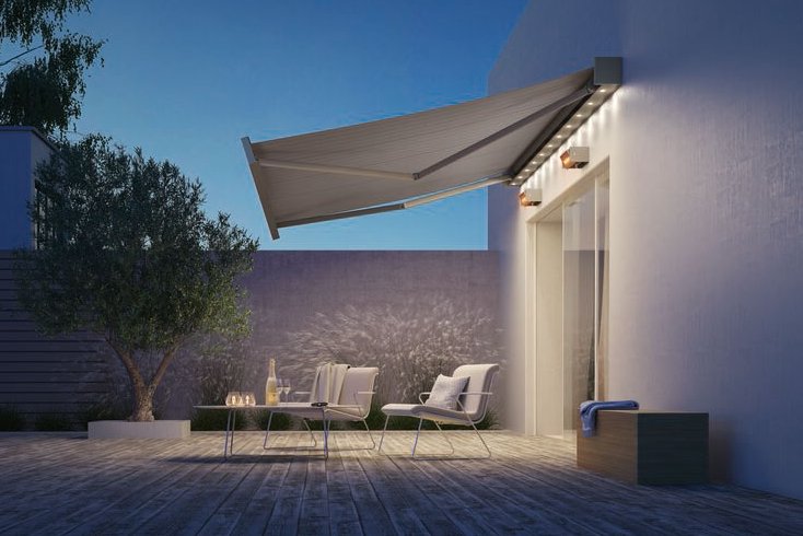 A modern terrace featuring a large awning, outdoor seating, and a calming evening atmosphere. A modern terrace featuring a large awning, outdoor seating, and a calming evening atmosphere.