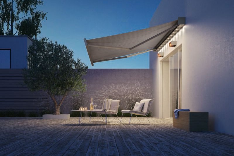 A modern terrace featuring a large awning, outdoor seating, and a calming evening atmosphere. A modern terrace featuring a large awning, outdoor seating, and a calming evening atmosphere.