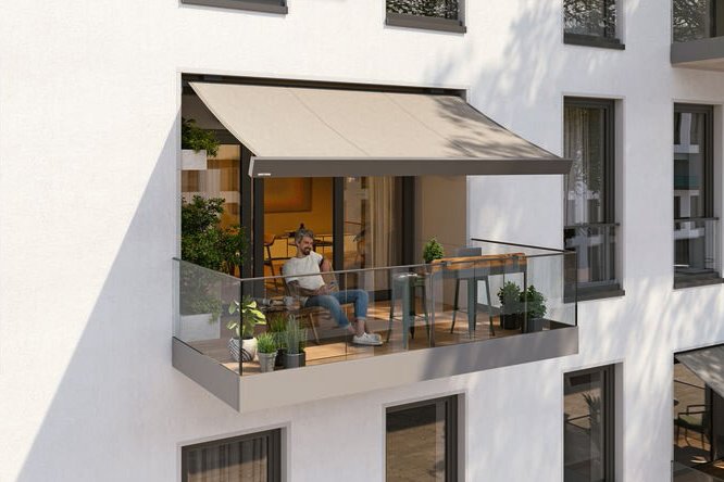 A modern balcony featuring a awning, glass railing, and a comfortable seating area. A modern balcony featuring a awning, glass railing, and a comfortable seating area.