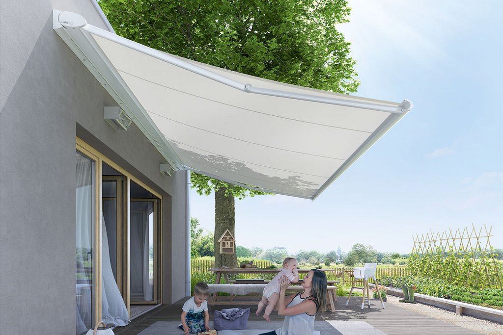 A white awning casting shade over a wooden terrace with a green tree in the background. A white awning casting shade over a wooden terrace with a green tree in the background.