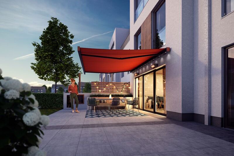 A modern patio with a red awning, greenery, and contemporary architecture in a twilight setting. A modern patio with a red awning, greenery, and contemporary architecture in a twilight setting.