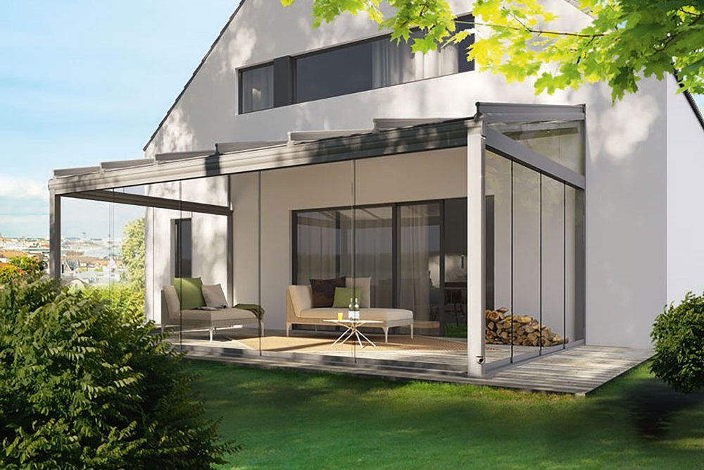 A modern house with a terrace featuring a sleek overhang, large windows, and greenery surrounding it. A modern house with a terrace featuring a sleek overhang, large windows, and greenery surrounding it.