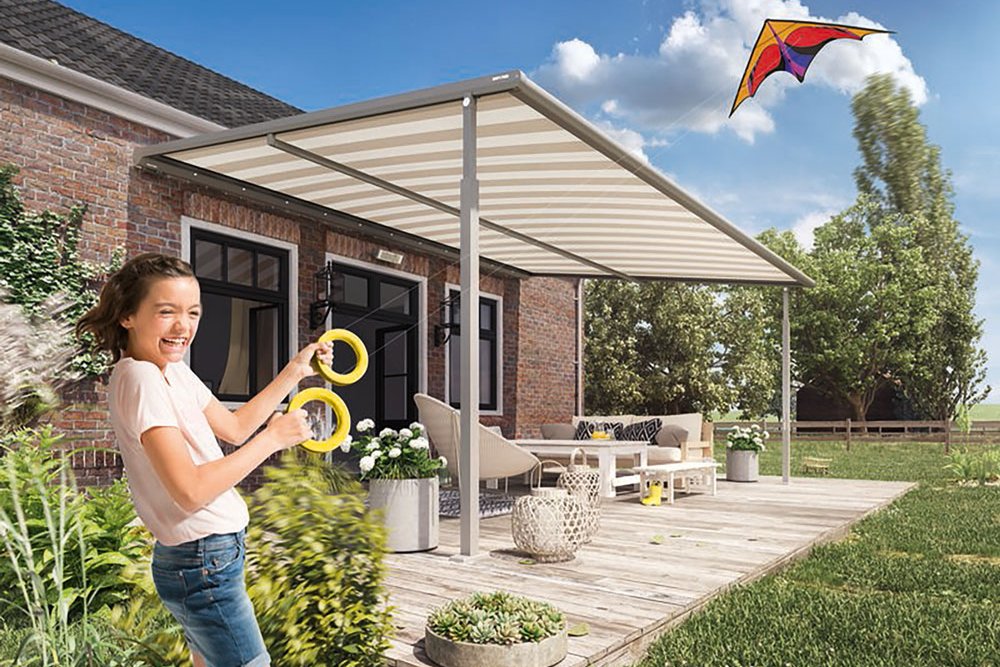 A child playing with rings under a stable roof structure in a sunny garden setting. A child playing with rings under a stable roof structure in a sunny garden setting.
