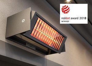 Wall-mounted heating unit with a black casing and orange heating element, next to a Red Dot award logo.